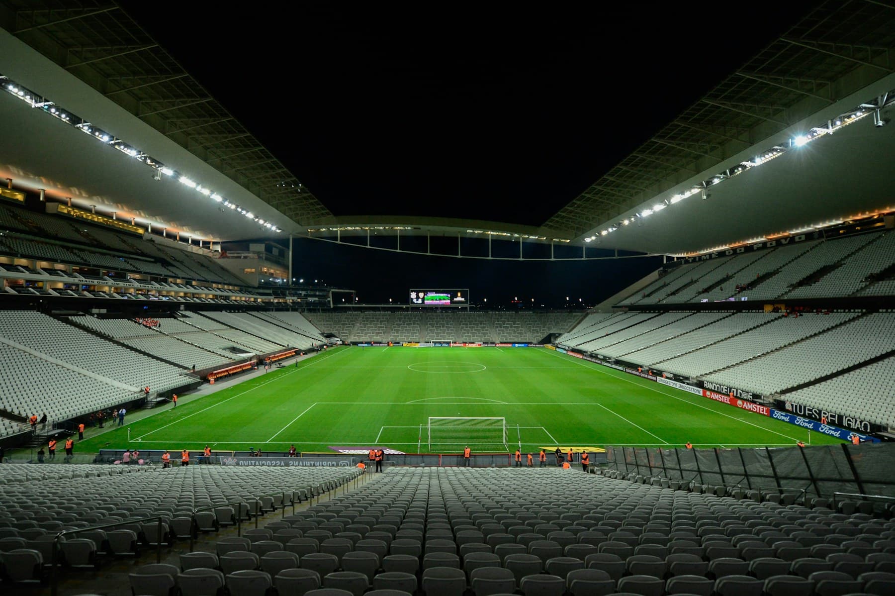 Football stadium illuminated for a night match