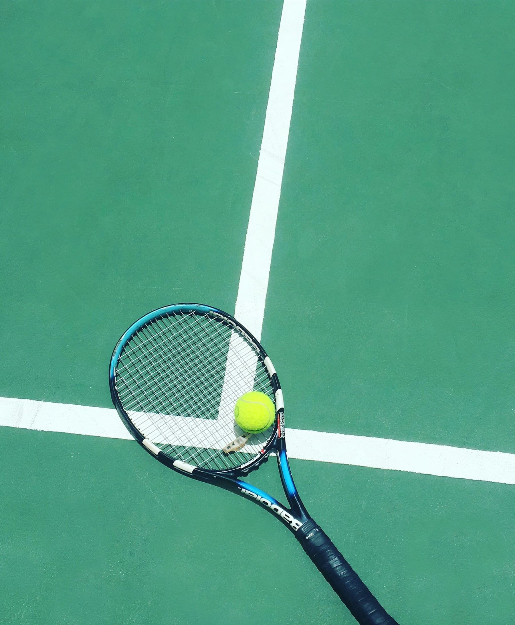 Tennis racket and ball on a court